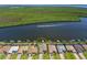 Aerial shot of waterfront home featuring a private pool and dock for boating or enjoying the water views at 15240 Spanish Point Dr, Port Charlotte, FL 33981