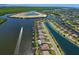 Stunning aerial view of a waterfront community with canals, lush greenery, and a boat speeding along at 15240 Spanish Point Dr, Port Charlotte, FL 33981