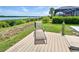Landscaped backyard with view of water and a lounge chair on a wooden deck at 15240 Spanish Point Dr, Port Charlotte, FL 33981