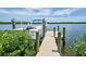 Private dock with a boat lift, offering direct access to the tranquil waters and scenic views at 15240 Spanish Point Dr, Port Charlotte, FL 33981