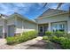 Inviting home exterior with landscaped walkway leading to the front door and well-maintained shrubs at 15240 Spanish Point Dr, Port Charlotte, FL 33981