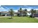 Lovely single-story home with a spacious lawn, mature landscaping, and a three-car garage at 15240 Spanish Point Dr, Port Charlotte, FL 33981