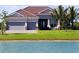 Charming single-story home with a well-manicured lawn and serene water view at 15240 Spanish Point Dr, Port Charlotte, FL 33981