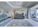 Living room with view of outdoor grill, pool, and waterway through sliding glass doors at 15240 Spanish Point Dr, Port Charlotte, FL 33981