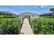 Back exterior of home showing backyard view and short wooden walkway at 15240 Spanish Point Dr, Port Charlotte, FL 33981