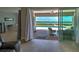 Living room view of patio, pool, and outdoor seating overlooking the water at 15240 Spanish Point Dr, Port Charlotte, FL 33981
