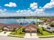 Aerial view of lakefront property with community pool at 8883 Tuscany Isles Dr, Punta Gorda, FL 33950