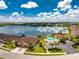 Aerial view of a villa community with lake and pool at 8883 Tuscany Isles Dr, Punta Gorda, FL 33950