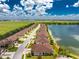 Aerial view of a villa community by a lake at 8883 Tuscany Isles Dr, Punta Gorda, FL 33950