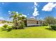Tan house with palm trees and well-manicured lawn at 8883 Tuscany Isles Dr, Punta Gorda, FL 33950