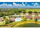 Aerial view of a villa community with pool and lake at 8883 Tuscany Isles Dr, Punta Gorda, FL 33950