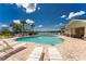 Relaxing community pool with lounge chairs and lake view at 8883 Tuscany Isles Dr, Punta Gorda, FL 33950