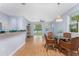 Dining area with lake view, hardwood floors, and wicker chairs at 8883 Tuscany Isles Dr, Punta Gorda, FL 33950