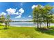 Scenic view of a tranquil lake with lush greenery and tree reflections at 8883 Tuscany Isles Dr, Punta Gorda, FL 33950