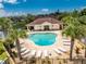 Community pool with lounge chairs and palm trees at 8883 Tuscany Isles Dr, Punta Gorda, FL 33950