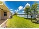 Lakefront backyard with grassy lawn and AC unit at 8883 Tuscany Isles Dr, Punta Gorda, FL 33950