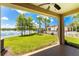 Covered patio overlooking lake, pool, and community clubhouse at 8883 Tuscany Isles Dr, Punta Gorda, FL 33950