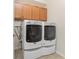 Laundry room with side-by-side washer and dryer, and upper cabinets at 8883 Tuscany Isles Dr, Punta Gorda, FL 33950