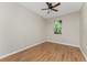 Bright bedroom featuring wood-look flooring and ceiling fan at 8883 Tuscany Isles Dr, Punta Gorda, FL 33950