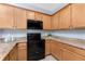 Well-equipped kitchen featuring wood cabinets and granite countertops at 8883 Tuscany Isles Dr, Punta Gorda, FL 33950