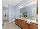 Double vanity bathroom with granite countertops and tile flooring at 8883 Tuscany Isles Dr, Punta Gorda, FL 33950