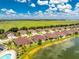 Aerial view of a villa community with pool and lake at 8883 Tuscany Isles Dr, Punta Gorda, FL 33950