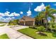 Two-car garage, tan house with landscaping and driveway at 8883 Tuscany Isles Dr, Punta Gorda, FL 33950