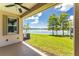 Covered patio with lake view and access to backyard at 8883 Tuscany Isles Dr, Punta Gorda, FL 33950