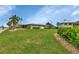 Landscaped backyard with canal views and mature vegetation at 1797 Boca Raton Ct, Punta Gorda, FL 33950