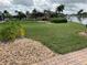 Landscaped backyard with lush lawn and canal views at 1797 Boca Raton Ct, Punta Gorda, FL 33950