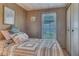 Cozy bedroom with striped bedding, window, and built-in closet at 5417 Holiday Park Blvd, North Port, FL 34287