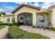 Inviting screened front entrance with a beautifully landscaped walkway and charming seating area at 2807 Via Paloma Dr, Punta Gorda, FL 33950