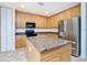 Island kitchen with stainless steel appliances and granite countertops at 85 Vivante Blvd # 8524, Punta Gorda, FL 33950