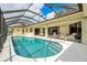 Inviting kidney-shaped pool with screened enclosure at 2807 Via Paloma Dr, Punta Gorda, FL 33950