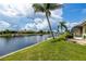 Waterfront backyard with lush landscaping, providing stunning canal views at 2807 Via Paloma Dr, Punta Gorda, FL 33950