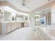 Spacious bathroom with double vanity, large tub, and mirrored walls at 2807 Via Paloma Dr, Punta Gorda, FL 33950