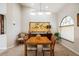 Elegant dining room featuring a wooden table and chairs, complemented by wall art and natural light at 2807 Via Paloma Dr, Punta Gorda, FL 33950