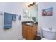Bathroom with granite countertop, wood cabinet and tiled walls at 85 Vivante Blvd # 8524, Punta Gorda, FL 33950