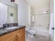 Bathroom with granite countertop, wood cabinet and tiled shower at 85 Vivante Blvd # 8524, Punta Gorda, FL 33950