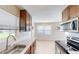 Eat-in kitchen, stainless steel appliances, and white subway tile at 8724 Agress Ave, North Port, FL 34287