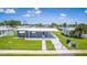 House with a blue exterior, large yard, and a walkway at 8724 Agress Ave, North Port, FL 34287