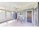 Bright screened porch with two chairs and backyard access at 8724 Agress Ave, North Port, FL 34287