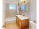 Clean bathroom with tub, vanity, and mirrored medicine cabinet at 8724 Agress Ave, North Port, FL 34287