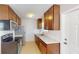 Galley style kitchen with stainless steel appliances at 8724 Agress Ave, North Port, FL 34287
