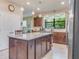 Updated kitchen with large island, granite countertops, and stainless steel appliances at 2555 Brassica Dr, North Port, FL 34289