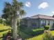Screened patio with a view of a palm tree and landscaping at 2555 Brassica Dr, North Port, FL 34289