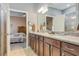 Modern bathroom with double sinks, granite counters, and a shower at 2555 Brassica Dr, North Port, FL 34289