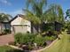 Single-Gathering home with a two-car garage and lush landscaping at 2555 Brassica Dr, North Port, FL 34289