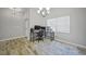 Bright home office features a corner desk, wood-look tile flooring, and window blinds at 725 Essex Ave, Port Charlotte, FL 33948