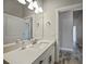Modern bathroom with white vanity and a view into hallway at 725 Essex Ave, Port Charlotte, FL 33948